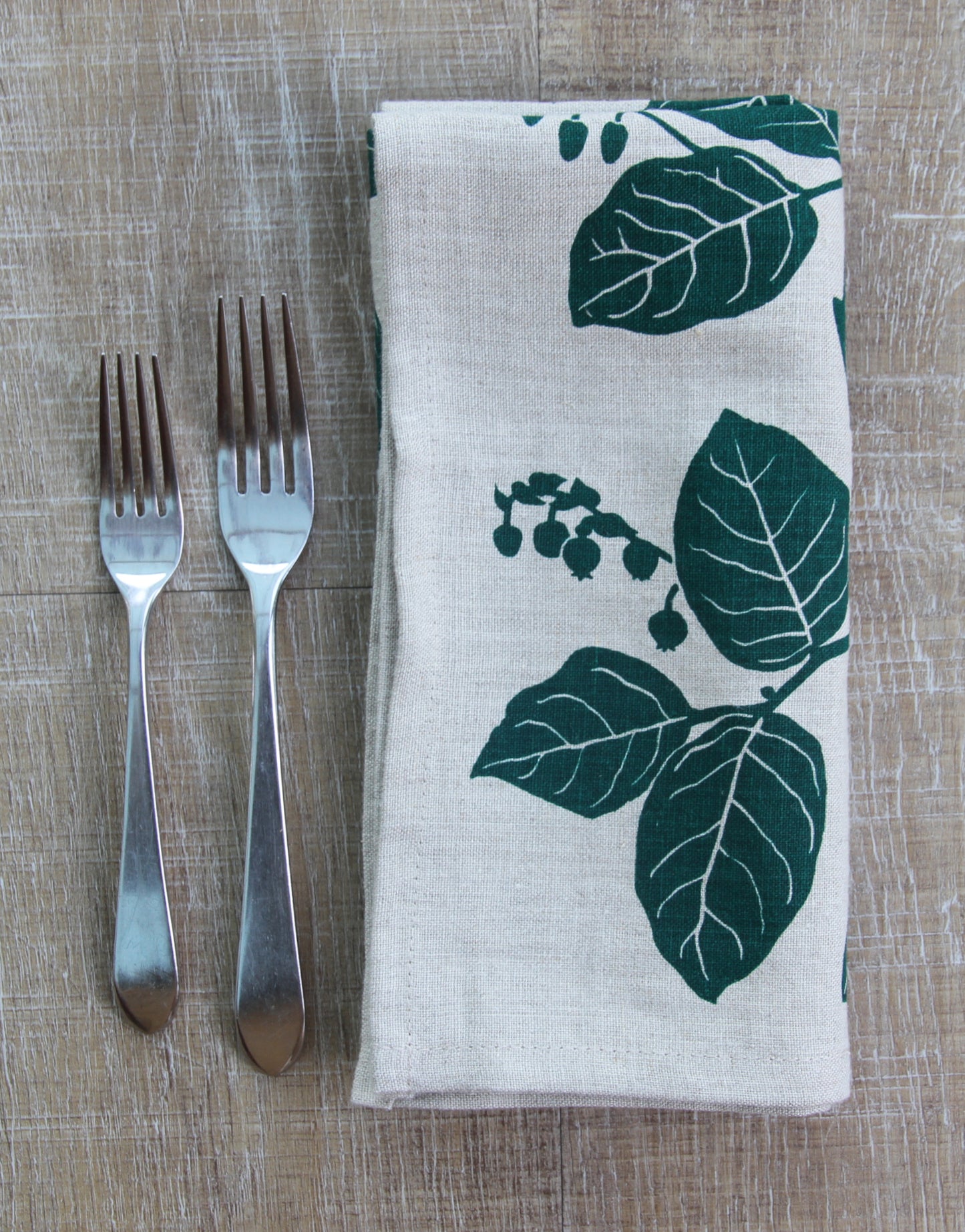 Salal Napkin in Hunter Green on Natural Linen