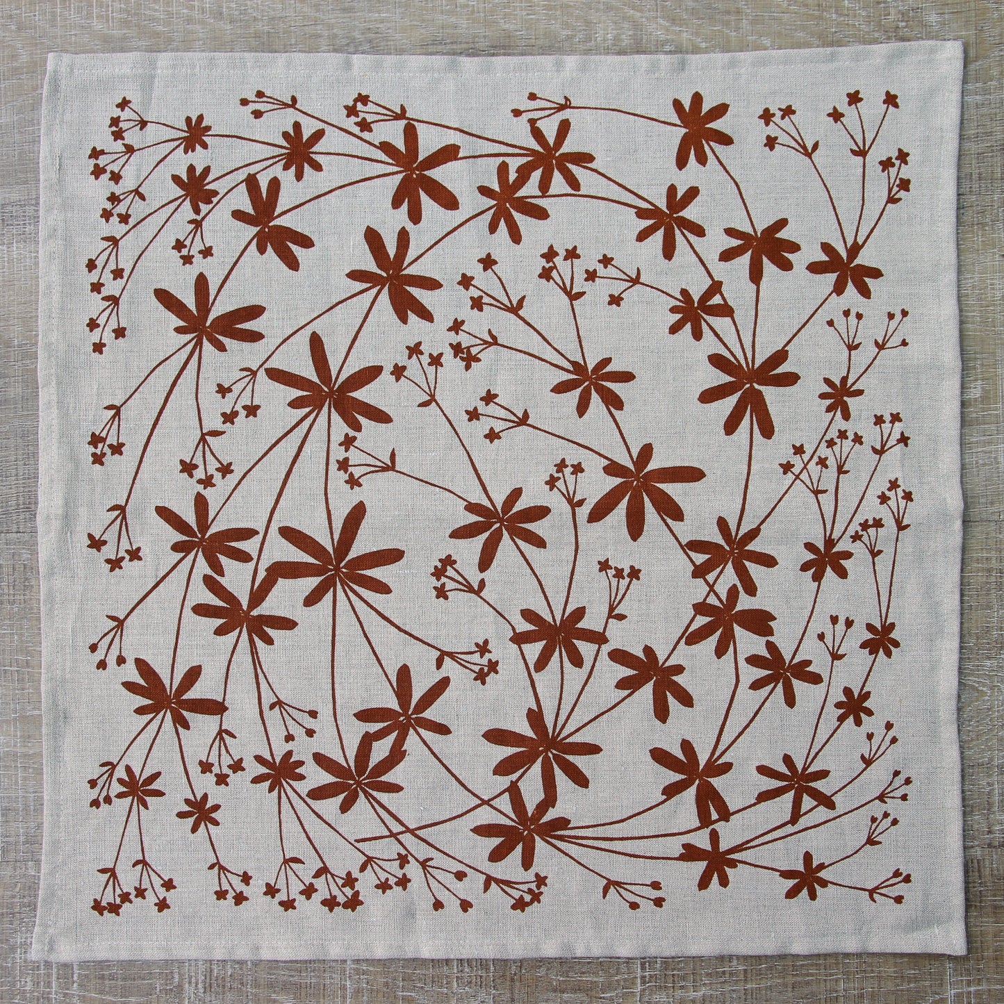 Bedstraw Napkin in Rust on Natural Linen