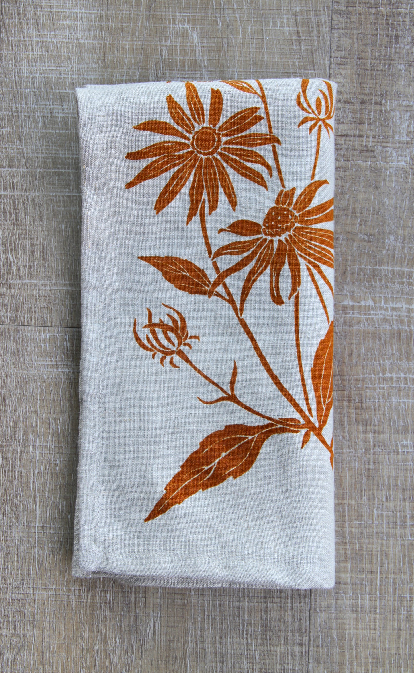 Black Eyed Susan Napkin in Cider on Natural Linen