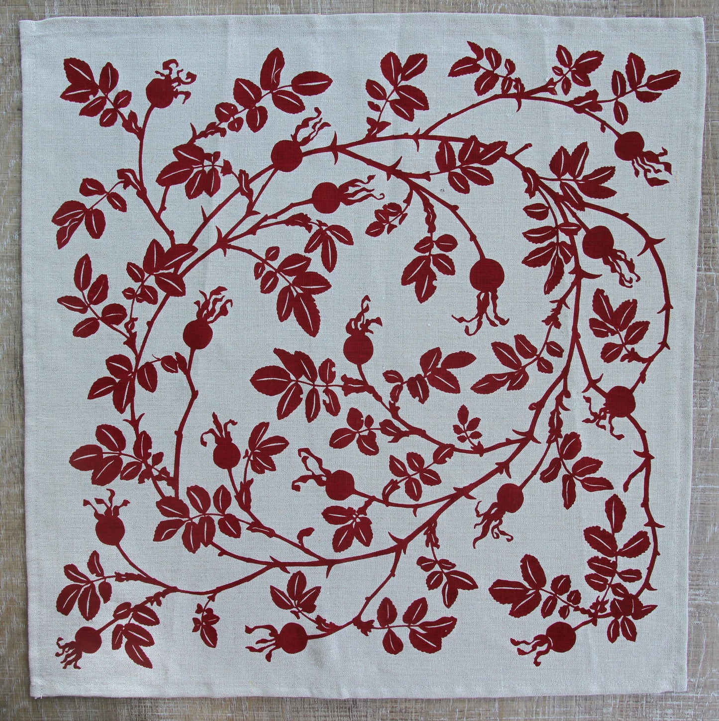 Nootka Rose Hip Napkin in Ruby on Natural Linen
