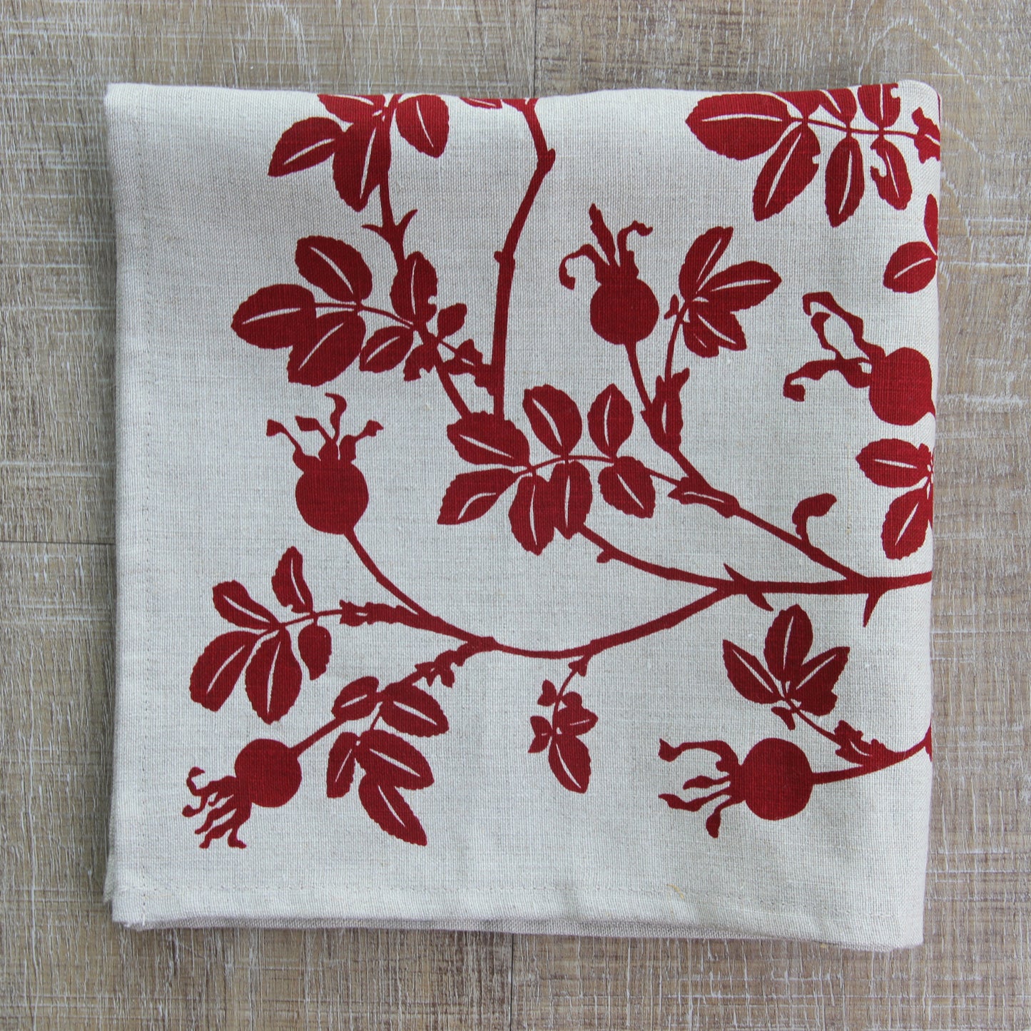 Nootka Rose Hip Napkin in Ruby on Natural Linen