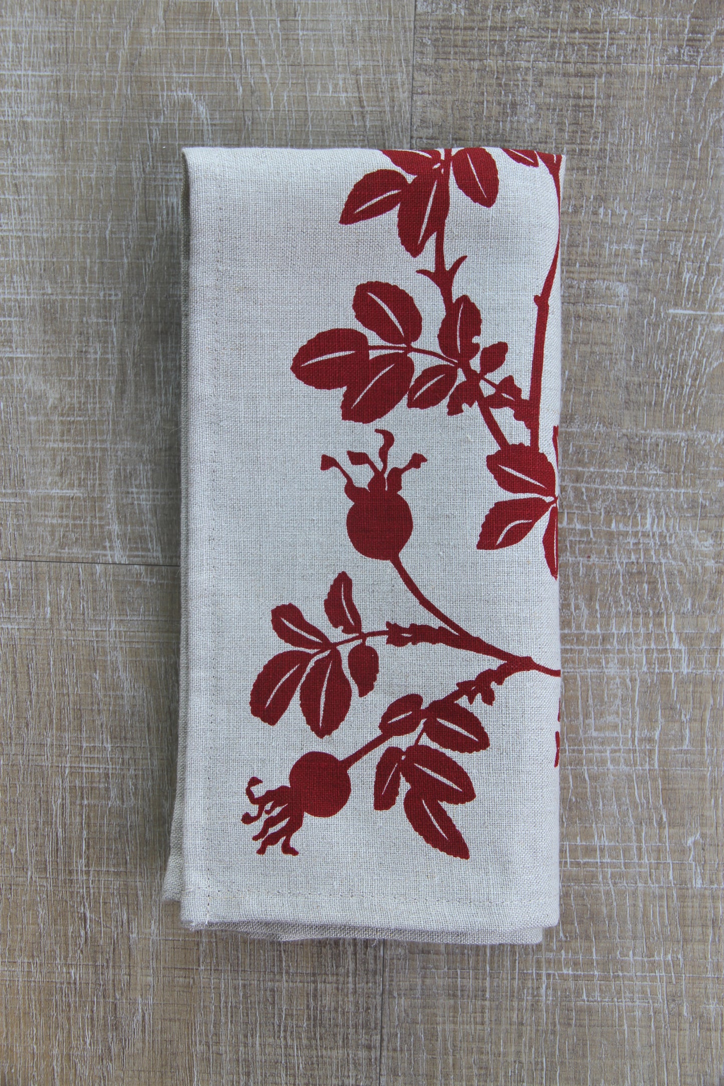 Nootka Rose Hip Napkin in Ruby on Natural Linen