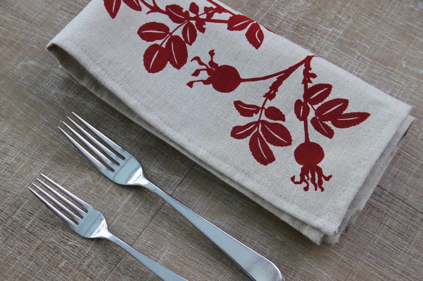 Nootka Rose Hip Napkin in Ruby on Natural Linen