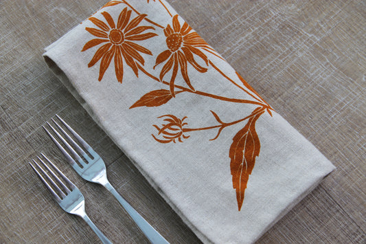 Black Eyed Susan Napkin in Cider on Natural Linen