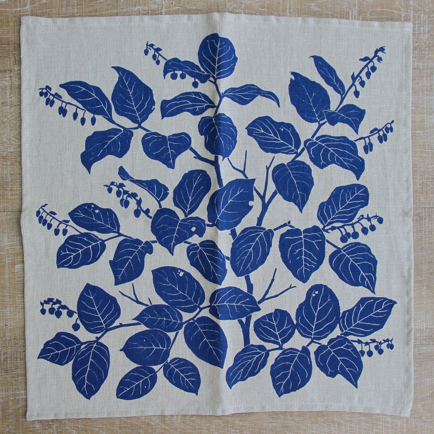 Salal Napkin in Cornflower on Natural Linen